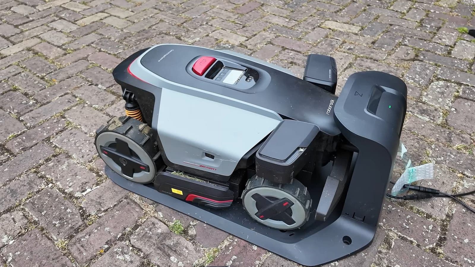 RockMow Z115 op het laadstation op klinkerbestrating