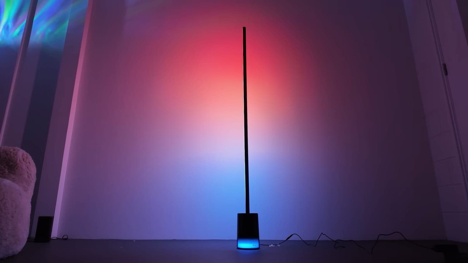 Govee Floor Lamp 2 glowing red and blue against a white studio wall