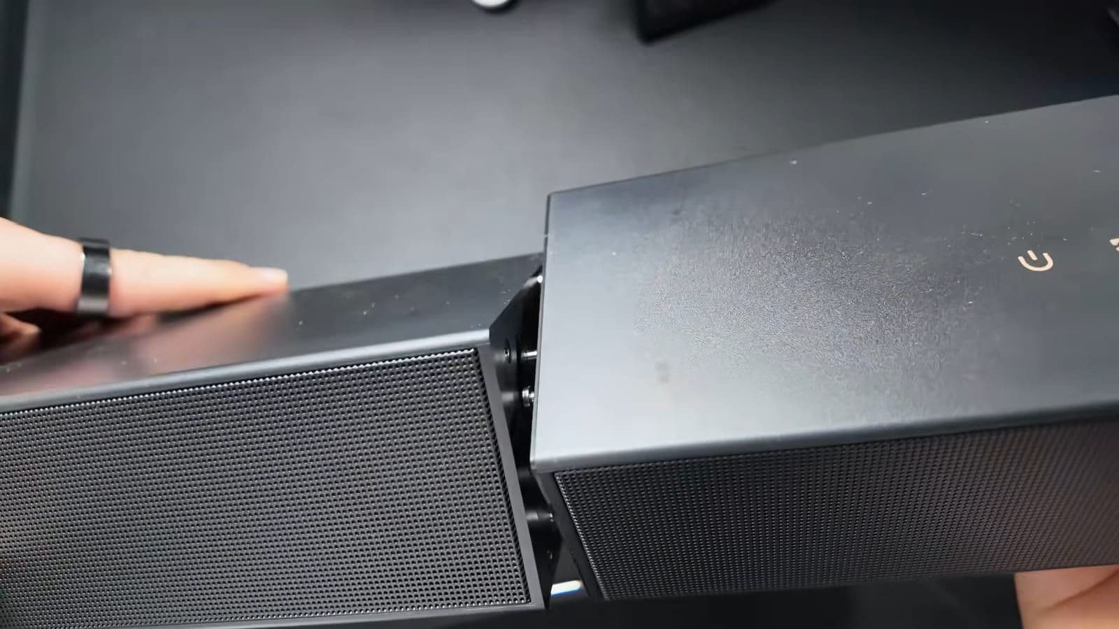 Assembling the modular soundbar pieces by snapping and locking them together