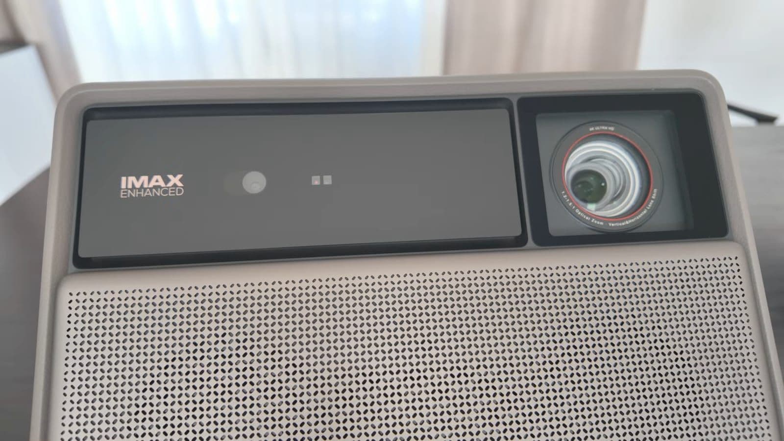 Close-up of projector lens and top panel showing Harman Kardon and IMAX Enhanced branding